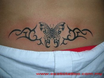 Tatuaje de una mariposa rodeada de tribales