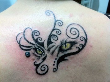 Tatuaje de unos ojos felinos con tribales rodenadolos