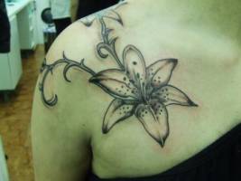 Tatuaje de una flor colgando de una enredadera