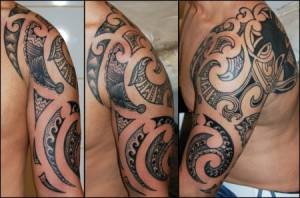 Tatuaje de tribales en el brazo y hombro
