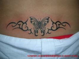 Tatuaje de una mariposa rodeada de tribales