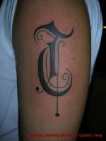 Tatuaje de una letra grande en el brazo