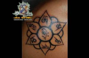 Tattoo de una flor de loto con mantras dentros