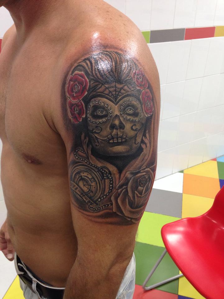 Tatuaje de una calavera mexicana con rosas y un reloj