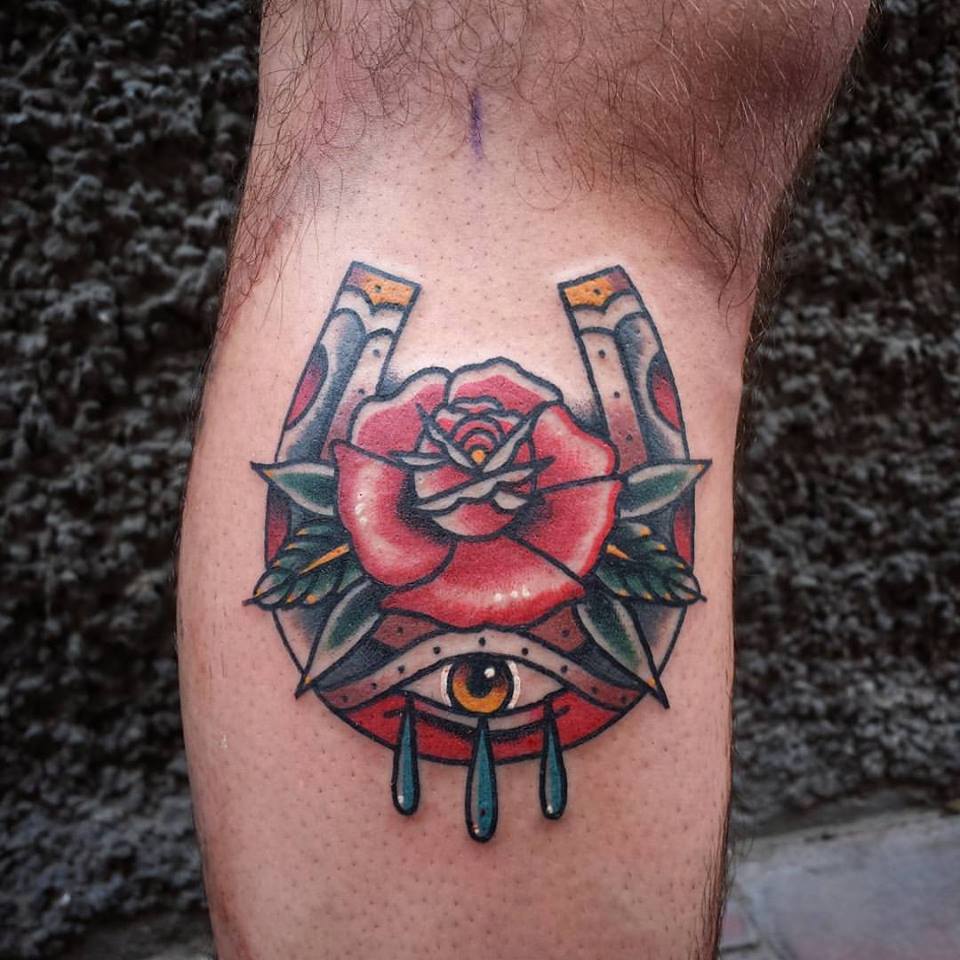 Tatuaje de una herradura con ojo llorando y una rosa