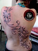 Tatuaje para mujeres, flores con sanefas. Tatuaje que cruza la espalda