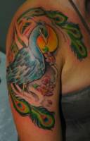 Tatuaje de un ave fénix en el atardecer