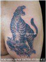 Tatuaje de un tigre encima de una piedra. Tattoo en blanco y negro