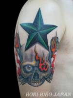 Tatuaje de calavera con fuego en los ojos y una estrella.
