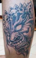Tatuaje de un demonio con una corona de calaveras