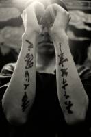 Tatuaje de unos kanjis escritos a pincel en el antebrazo