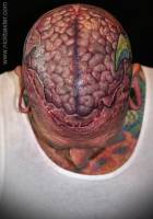 Tatuaje en la cabeza, de piel desgarrada mostrando el cerebro