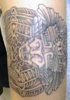 Tatuaje de un disco con una cabeza maya
