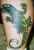 Tatuaje de una salamandra subiendo por la pierna