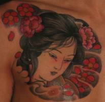 Tatuaje de una cara de geisha entre flores