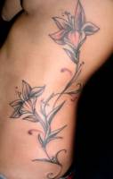 Tattoo de flores en el costado para una mujer
