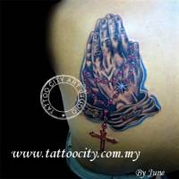Tatuaje de unas manos rezando con un rosario