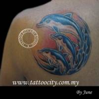 Tatuaje de tres delfines saltando del agua