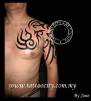 Tatuaje de un tribal en brazo y pecho
