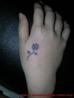 Tatuaje de una pequeña rosa en la mano