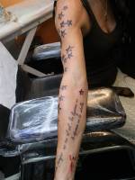 Tatuajes de estrellas en el brazo con una frase