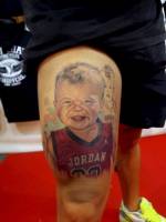 Tatuaje retrato a color de un niño con la camiseta de Jordan