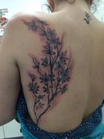 Planta tatuada en la espalda de una chica