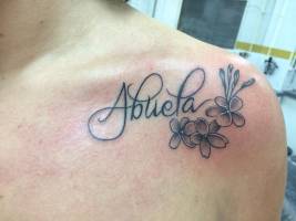 Tatuaje de la palabra Abuela y unas flores