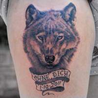Tatuaje de un lobo y una cinta con una fecha
