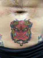 Tatuaje de una cara de león chino debajo del ombligo