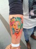 Tattoo de un león hecho de manchas de pintura