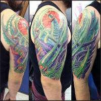 Tatuaje biomecánico en hombro y brazo