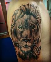 Tattoo de una cara de león en el brazo