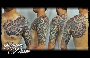 Tattoo de un dragón en brazo y espalda